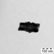 Picture of a hybrid particle taken by a transmission electron microscope. Pictured are the inorganic (dark) and organic (light) lamellas that the particle is made of, as well as the tubular shapes (the low-contrast area in the middle). Through vaporisation with Europium, the hybrid stage can be transformed into pure EuO. Copyright: University of Konstanz