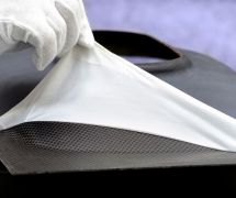 Removal of FlexPLAS® release film from a contaminant-free CFRP component after curing in the hot press. © Fraunhofer IFAM